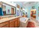 Beautiful bathroom with double sinks, soaking tub, and a decorative mirror offering style and function at 14315 Rolling Dune Rd, Lithia, FL 33547