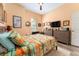Bedroom with a ceiling fan, bed with colorful bedding, and wall-mounted TV above a dresser at 14315 Rolling Dune Rd, Lithia, FL 33547