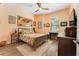 Comfortable bedroom with a ceiling fan, window with blinds, and a stylish bed with colorful bedding at 14315 Rolling Dune Rd, Lithia, FL 33547