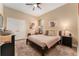 Bedroom with a bed, ceiling fan, carpet, and neutral-colored walls with art pieces hanging at 14315 Rolling Dune Rd, Lithia, FL 33547