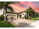 Charming one-story home with a 2-car garage, brick-paved driveway, and tropical landscaping at 14315 Rolling Dune Rd, Lithia, FL 33547