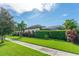 Sidewalk view of a home featuring manicured shrubs, a lawn, and a screened-in lanai at 14315 Rolling Dune Rd, Lithia, FL 33547