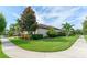 Lush green lawn surrounds this well-maintained home featuring mature trees and manicured bushes at 14315 Rolling Dune Rd, Lithia, FL 33547