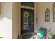 Charming front door with decorative accents and a cozy seating area at 14315 Rolling Dune Rd, Lithia, FL 33547