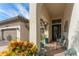 Inviting front porch with brick pavers, colorful plants, and a view of the garage at 14315 Rolling Dune Rd, Lithia, FL 33547
