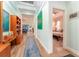 Inviting hallway with wood floors and a view into the living area and bedroom at 14315 Rolling Dune Rd, Lithia, FL 33547
