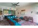 Bright lanai with seating area, ceiling fan, stone floors and views of the screened in pool at 14315 Rolling Dune Rd, Lithia, FL 33547