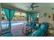 Spacious lanai with ceiling fan, stone flooring, comfortable seating and view of the screened-in pool at 14315 Rolling Dune Rd, Lithia, FL 33547