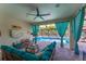 Lanai with ceiling fan, stone flooring, comfortable seating and view of the screened-in pool at 14315 Rolling Dune Rd, Lithia, FL 33547
