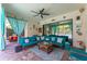 Spacious lanai with ceiling fan, stone flooring, comfortable seating and views of the screened-in pool at 14315 Rolling Dune Rd, Lithia, FL 33547