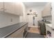 Modern laundry room with gray cabinetry, a gray countertop, and a gray washer and dryer set at 14315 Rolling Dune Rd, Lithia, FL 33547