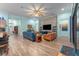 Open-concept living room featuring tile floors, a stone accent wall, and open access to the kitchen at 14315 Rolling Dune Rd, Lithia, FL 33547