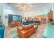 Open-concept living room featuring modern decor, tile floors, and sliding glass doors at 14315 Rolling Dune Rd, Lithia, FL 33547