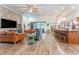 Open-concept living room featuring a stone accent wall, modern furnishings, and tile floors at 14315 Rolling Dune Rd, Lithia, FL 33547