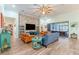 Bright living room featuring tile floors, comfortable seating, and a sliding glass door to outdoor area at 14315 Rolling Dune Rd, Lithia, FL 33547