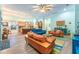 Open-concept living room with a modern kitchen, wood floors, stylish furniture, and bright, colorful accents at 14315 Rolling Dune Rd, Lithia, FL 33547