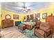 Spacious main bedroom featuring a tray ceiling, wood furniture, and a comfortable sitting area at 14315 Rolling Dune Rd, Lithia, FL 33547