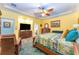 Comfortable main bedroom with wood flooring, ceiling fan, and a cozy seating area at 14315 Rolling Dune Rd, Lithia, FL 33547