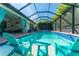 Screened-in pool with cool blue water, stone deck, conversation set and view of the home at 14315 Rolling Dune Rd, Lithia, FL 33547