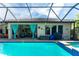 Sparkling screened-in pool with stone deck and views of the lanai and home at 14315 Rolling Dune Rd, Lithia, FL 33547