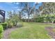 Well-maintained backyard with lush green lawn and mature landscaping, perfect for outdoor activities and relaxation at 144 Silver Falls, Apollo Beach, FL 33572