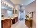 Bathroom with dual sinks, decorative fixtures, ample counter space, and white tile flooring at 144 Silver Falls, Apollo Beach, FL 33572