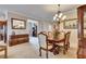 Elegant dining room featuring a chandelier, wood table, and classic decor at 144 Silver Falls, Apollo Beach, FL 33572