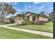 Beautiful single-Gathering home with a two-car garage, well-manicured lawn and lush tropical landscaping at 144 Silver Falls, Apollo Beach, FL 33572