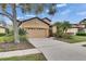 Inviting single-Gathering home with a two-car garage, well-manicured lawn and mature landscaping at 144 Silver Falls, Apollo Beach, FL 33572