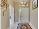 Bright foyer with tile flooring, decorative rug, transom window, and elegant front door at 144 Silver Falls, Apollo Beach, FL 33572