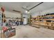 This garage features built-in shelves and fluorescent lighting, offering ample storage and functionality at 144 Silver Falls, Apollo Beach, FL 33572
