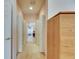 Hallway view featuring doorways leading to other rooms and a light wood storage unit at 144 Silver Falls, Apollo Beach, FL 33572