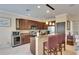 Kitchen boasts granite counters, dark wood cabinetry, stainless appliances, and breakfast bar with seating at 144 Silver Falls, Apollo Beach, FL 33572