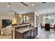 Open kitchen with granite countertops, stainless steel appliances, and breakfast bar overlooking the living area and dining room at 144 Silver Falls, Apollo Beach, FL 33572