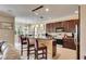 Spacious kitchen featuring dark cabinetry, stainless steel appliances, granite countertops, and breakfast bar with seating at 144 Silver Falls, Apollo Beach, FL 33572
