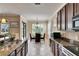 Open concept kitchen with stainless steel appliances, granite countertops, and breakfast bar, flowing into dining area at 144 Silver Falls, Apollo Beach, FL 33572