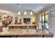 Open concept kitchen with stainless steel appliances, granite countertops, breakfast bar, and views to the living area at 144 Silver Falls, Apollo Beach, FL 33572