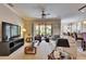 Comfortable living room with a ceiling fan, sliding glass doors to the lanai, and neutral decor at 144 Silver Falls, Apollo Beach, FL 33572