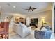 Bright living room with neutral carpet, ceiling fan, and comfortable seating at 144 Silver Falls, Apollo Beach, FL 33572