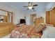 Main bedroom features light wood furnishings, ceiling fan, and adjacent to the hallway and bathroom at 144 Silver Falls, Apollo Beach, FL 33572