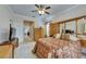 Spacious main bedroom featuring a ceiling fan, wood furnishings, and a view into the hallway at 144 Silver Falls, Apollo Beach, FL 33572
