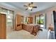 Brightly lit main bedroom with ceiling fan, light wood furnishings, and sliding glass doors to the patio at 144 Silver Falls, Apollo Beach, FL 33572