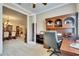 Comfortable office area with custom wood desk and cabinetry; Dining room and living area are adjacent at 144 Silver Falls, Apollo Beach, FL 33572