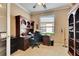 Bright office space with a wooden desk, built-in shelving, and a large window overlooking the exterior at 144 Silver Falls, Apollo Beach, FL 33572
