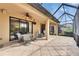 This patio features a ceiling fan, tiled flooring, and sliding glass doors, offering a seamless indoor-outdoor living experience at 144 Silver Falls, Apollo Beach, FL 33572