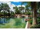 Scenic view of the community pond featuring a waterfall and lush tropical landscaping, creating a tranquil setting at 144 Silver Falls, Apollo Beach, FL 33572