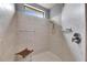 This walk-in shower features neutral tile and a built-in bench at 144 Silver Falls, Apollo Beach, FL 33572