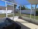 Enjoy the outdoors bug-free in this screened-in patio with hot tub and views of the backyard at 15015 Trail Creek Pl, Tampa, FL 33625