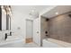 This bright bathroom features double sinks and modern shower and bath at 15921 Wyndover Rd, Tampa, FL 33647