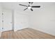 This is a bright bedroom featuring wood floors, ceiling fan, and double door closet at 15921 Wyndover Rd, Tampa, FL 33647